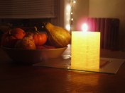 fall gourds and lit candle