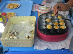 Cooking up quail eggs--which are then sprinkled with pepper and soy sauce, yum