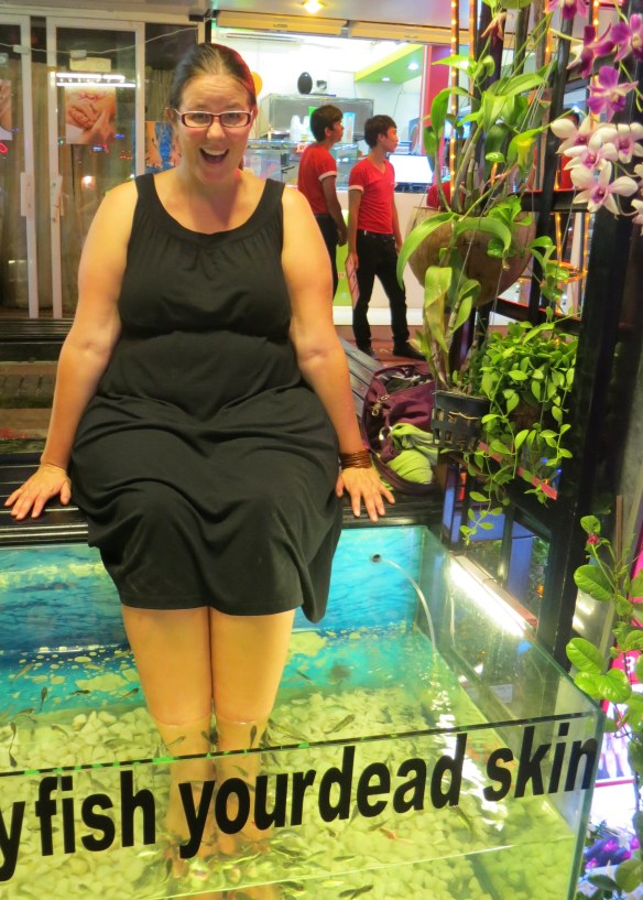 The sign on the tank reads, "Please feed our hungry fish your dead skin"