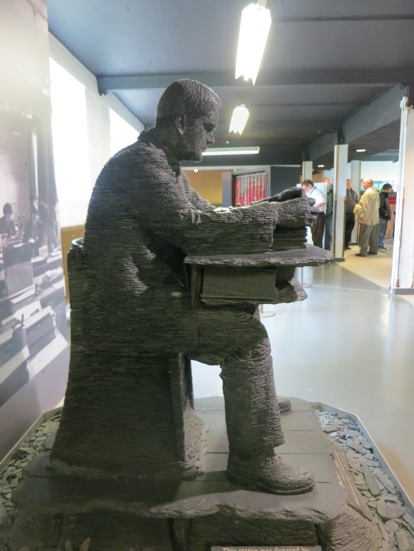 Stephen Kettle's slate statue of Alan Turing at work